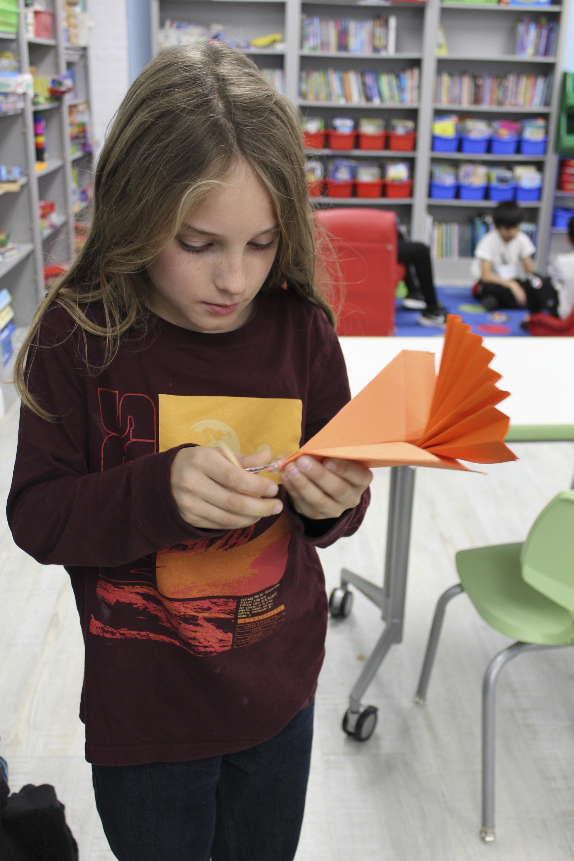 after school child making paper flying turkey