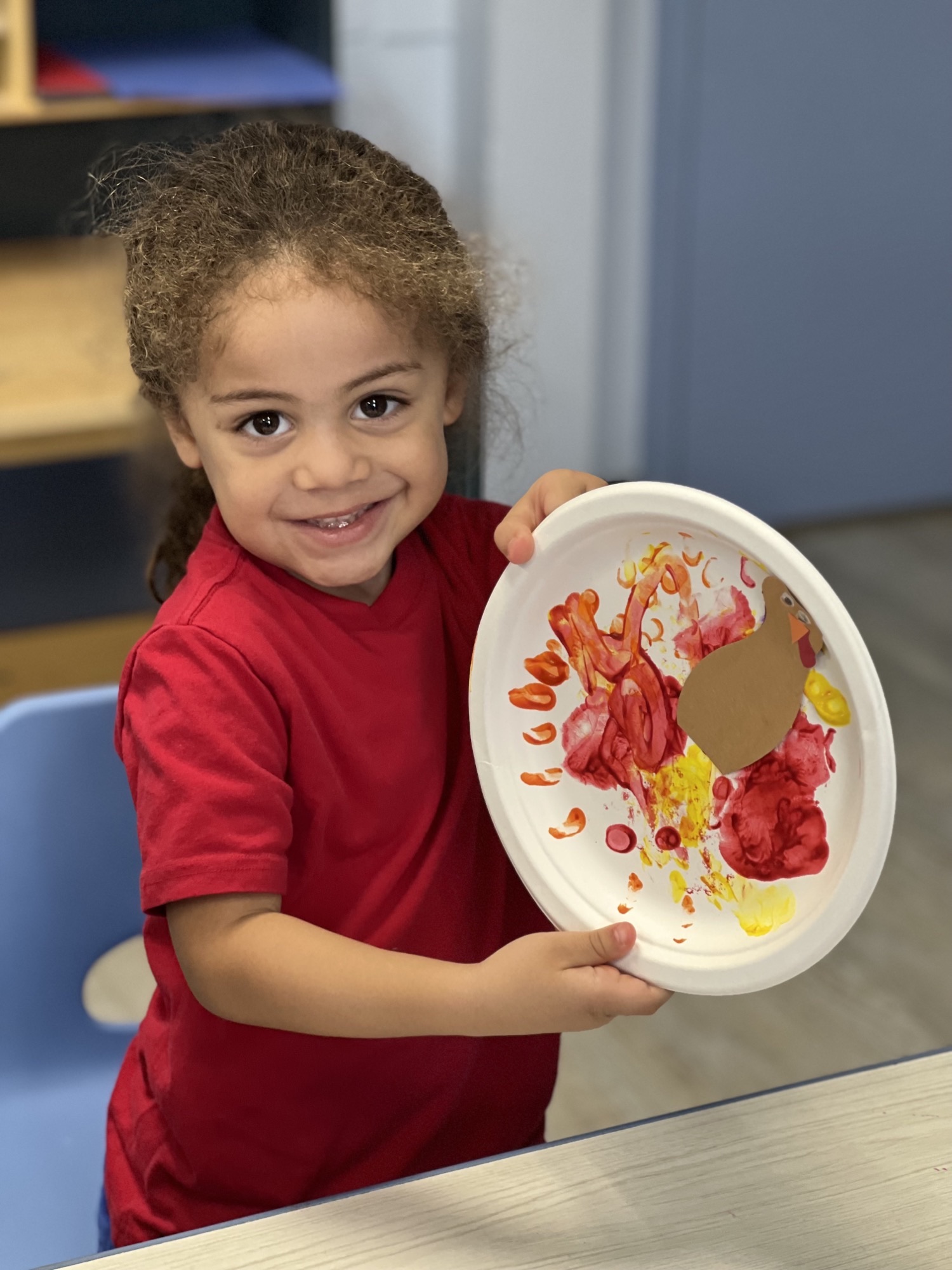 Preschooler showing turkey painting